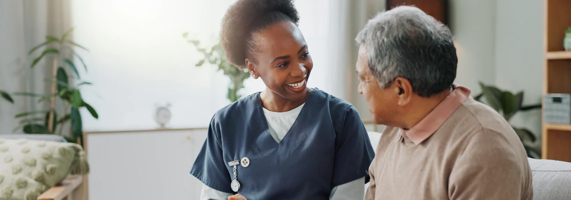 Caregiver and patient sitting in a living room