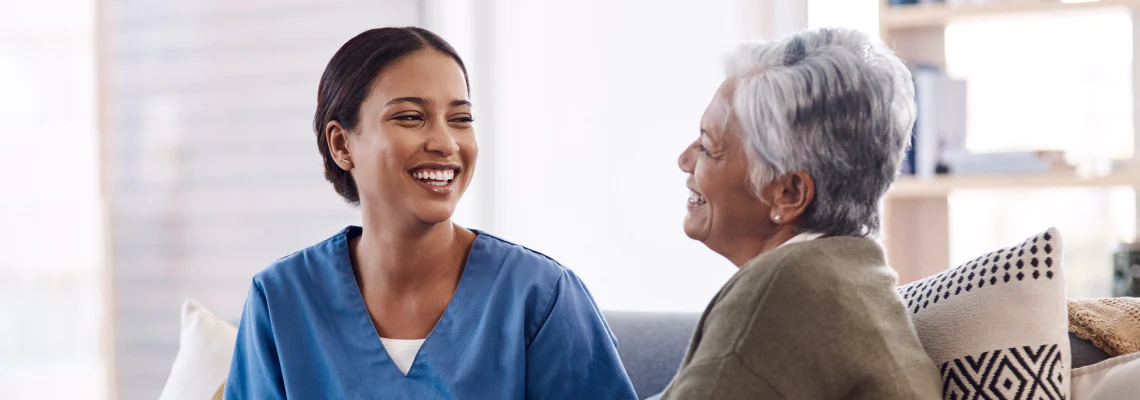 Caregiver smiling with a patient.